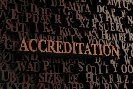 Accreditation - Wooden 3D rendered letters/message.  Can be used for an online banner ad or a print postcard.